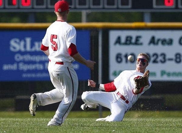 Photo courtesy of Saed Hindash | For lehighvalleylive.com. Easton's Greg Albertson tries to make a sliding catch against Liberty in the District 11 quarterfinals.